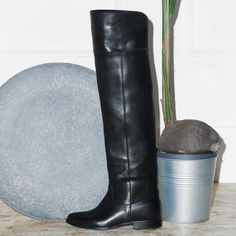 These boots combine the classical riding style with the boldness of the cuissardes. The straight leather shaft follow the leg shape without constraining. Wear them with a supple wool dress or with blazer dress for a daily casual but really bold look. Choose the calf circumference and height that best fit you, click the button above to get to know how to correctly measure your calf. Details: Fine calfskin upper Leather lining, leather insole Leather sole with a non-slip rubber insert Over-the-Kne Elegant Workwear Moto Boots With Leather Lining, Elegant Winter Moto Boots With Leather Sole, Knee-high Moto Boots For Work, Knee-high Moto Boots For Workwear, Winter Workwear Knee-high Calf Leather Boots, Classic Black Fitted Knee-high Boots, Classic Office Boots For Winter, Classic Winter Office Boots, Elegant Leather Sole Knee-high Boots For Riding