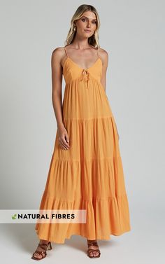 Get ready to turn heads in the Chila Maxi Dress! This stunning papaya orange dress features a strappy tie-front design and a low back for a flirty touch. The tiered A-line silhouette adds movement and flow, while the sleeveless style keeps you cool during those warm summer days. Made from soft cotton fabric, this casual dress is both comfortable and stylish. Whether you're attending a brunch with friends or going out for date night, the Chila Maxi Dress is bound to make you feel confident and be Summer Tiered Maxi Dress With Tie Back, Beach Tiered Maxi Dress With Tie Straps, Tiered Maxi Dress With Tie Straps For Beach, Orange Vacation Dress With Adjustable Straps, Orange Dress With Adjustable Straps For Vacation, Sleeveless Tie Back Tiered Beach Dress, Sleeveless Tie Back Tiered Dress For Beach, Tiered Maxi Dress With Tie Straps For Vacation, Sleeveless Tiered Dress With Tie Back For Beach