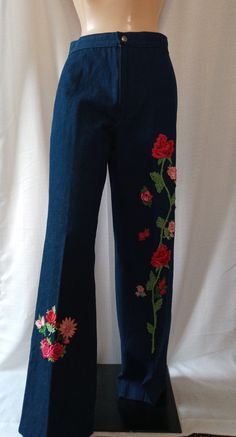 a mannequin wearing blue pants with red flowers on them