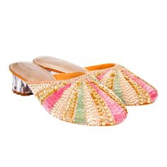 A Strip Of White Beads, Followed By Golden Sequins And Zardosi And Then One Of Either Pink Or Green Sallis Converging At The Centre To Resemble The Rays Of The Sun. These Rose Gold Mules Have Almost A Flower Shaped Transparent Heel With A Broad Base For Extra Comfort. This Pair Like Its Name Kiran Is Bound To Emit Radiance To Your Look. Suitable For- Dinners, Lunches, Casual Meetings, Festivals, And Semi-Formal Occasions Heel Size - 2 Inches Heel Type - Transparent Block Material - Silk,Wood,Pvc Beaded Heels For Party, Beaded Heels For Evening In Summer, Beaded Heels For Evening Summer Occasions, Summer Evening Beaded Heels, Beaded Heels For Formal Summer Events, Summer Wedding Sandals With Sequins, Summer Formal Beaded Heels, Multicolor Embellished Heels With Round Toe, Multicolor Embellished Open Toe Heels