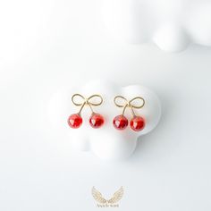 These charming bow cherry earrings are made of 925 sterling silver and feature delicate gold plating with red agate accents. The playful design, combining a cute bow with dangling cherries, adds a whimsical touch to any outfit. Perfect for adding a pop of color and fun,  This wonderful piece of jewelry will make a sweet, thoughtful, and precious gift for yourself or that special someone. Material: 925 Sterling Sliver/Red agate *Finishing: Gold plated *Size:13mm X12mm *Weight: 1.0g *Lead & Nickel free, hypoallergenic As with all delicate jewelry, they need love and care to maintain  their beauty for a long time. We recommend:   -Remove before showering or other water activities to  minimize contact with moisture or chemicals  -Avoid exposure to liquids and cosmetics -Do not wear while sleep Elegant Cherry Colored Jewelry For Party, Elegant Cherry Drop Earrings, Cherry Colored Jewelry For Valentine's Day Party, Cherry-colored Jewelry For Valentine's Day Party, Cherry Color Jewelry For Valentine's Day Party, Cherry Jewelry For Valentine's Day Party, Elegant Cranberry Jewelry For Gift, Cherry Colored Earrings For Valentine's Day Gift, Cherry Colored Earrings Gift