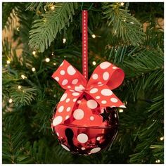 an ornament hanging from a christmas tree decorated with red and white polka dots