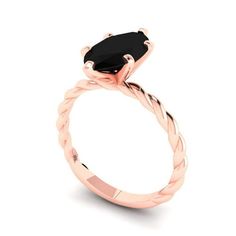 a rose gold engagement ring with an oval black diamond in the center and twisted band