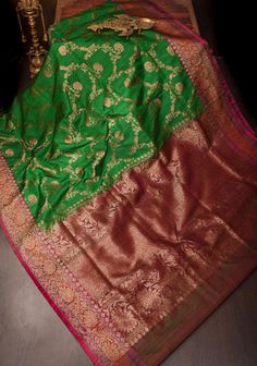 The Green Dupion Banarasi Silk Saree with Antique Zari Floral Jaal is a splendid fusion of traditional craftsmanship and elegant design. This saree features a rich green hue, beautifully contrasted by the intricate antique zari floral jaal that adorns its entirety. The luxurious dupion silk fabric adds a subtle texture and sheen, enhancing the overall allure of the saree. Perfect for festive occasions and weddings, this saree exudes a timeless charm, making it a cherished addition to any wardrobe SILK MARK CERTIFIED This saree is ready to wear with fall and pico done. Handmade silk tassels adorn the pallu and add more grace to it. An unstitched blouse fabric is included. *Note: There may be minor variations in the shade, the texture of the product. Hues/textures show differently due to var Luxury Green Banarasi Silk Pre-draped Saree, Luxury Banarasi Silk Saree For Designer Wear, Luxury Banarasi Silk Blouse For Wedding, Luxury Banarasi Silk Festive Blouse, Luxury Green Banarasi Silk Traditional Wear, Luxury Saree Fabric With Pallu, Luxury Banarasi Silk Designer Saree, Luxury Banarasi Silk Traditional Wear, Luxury Designer Banarasi Silk Traditional Wear