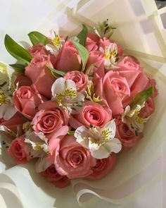 a bouquet of pink roses and white orchids