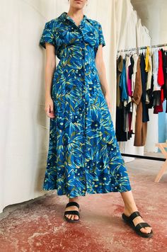 "Vintage Floral  Maxi Dress - Small - Medium Modeled on a size small Button closure 15in from hem - Photo depicts opened closure 100% Rayon Flat measurements: 38\"Bust 34\"Waist  ( adjustable fit with tie at waist) 52\"Length" Floral Print Button-up Midi Dress For Vacation, Green Button-up Maxi Dress For Beach, Floral Print Button-up Midi Dress For The Beach, Fitted Floral Print Button-up Maxi Dress, Green Fitted Button-up Maxi Dress, Floral Print Button-up Maxi Dress For Vacation, Fitted Beach Dress With Button Closure, Blue Fitted Maxi Dress With Button Closure, Fitted Blue Maxi Dress With Button Closure