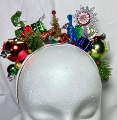 Add holiday spirit to your hairstyle with this fun, bright , tacky headband ! Handmade using festive holiday ornaments that sparkle and shine, set on a 1 inch wide, satin headband . Each unique headband is handcrafted with great care and  attention to detail . A perfect and fun  accessory for all of your holiday festivities!  Headband is 13 inches from end to end, over the head .   Headband contains small embellishments that can be a choking hazard to small children.  HANDLE EMBELLISHED HEADBAND Christmas Hair Band, Holiday Headpiece, Festive Hair, Unique Headband, Embellished Headband, Headband Handmade, Satin Headband, Embellished Headbands, Creative Costumes