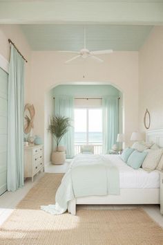 a bed room with a neatly made bed next to a window and a ceiling fan