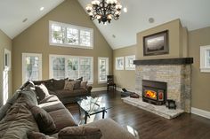 a living room filled with furniture and a fire place in the middle of a room