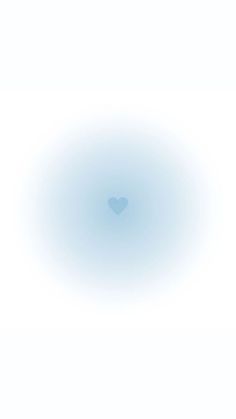 a blue circle with a heart in the middle on a white background that appears to be blurry