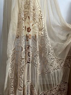 RARE and Beautiful ! Antique 1910s -1920s beige lace curtain with beautiful details, all handworked and hand embroidered with cotton and silk. The color is beige. ✂-----Measurements : length: 100 inches width: 65 inches condition : excellent ( no holes ) Please message me if any additional measurements are needed or if you have any questions about this item. I can usually respond within 24 hours. Shipping Is Avaliable Worldwide. Every item is carefully shipped Priority via Air Mail - shipping ta Bohemian Beige Embroidered Fabric For Wedding, Dyed Lace Curtains, Victorian Lace Curtains, Cream Bohemian Embroidered Fabric, Lace Patchwork Curtains, Beige Lace Fabric With Floral Embroidery, Bohemian Beige Embroidered Fabric, Bohemian Beige Fabric With Intricate Embroidery, Beige Lace Fabric With Intricate Embroidery