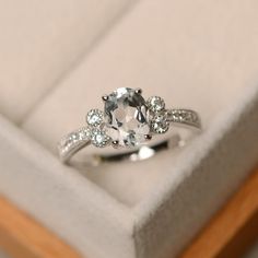 an engagement ring in a white box