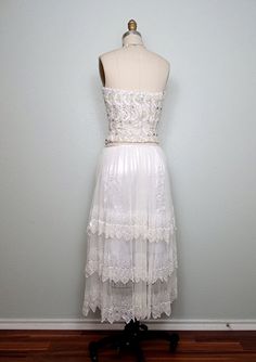 "This is an breathtaking vintage couture piece from Lillie Rubin! It's completely hand sewn with pearl beading, iridescent sequins, white glass beading and rhinestone crystals. Absolutely gorgeous It's in perfect condition! Measurements: Bust - 32\" Waist - 25\" Length - 13\" in the front and 9\" in the back (note, there is a zipper closure in the back going from top to bottom) Skirt Waist - 26/27\" (note, there is a side zipper with hook & eye closure above and no stretch in the material) S Wedding Corset With Sequins And Fitted Bodice, Embellished Strapless Corset For Wedding, Embellished Strapless Wedding Corset, Strapless Embellished Wedding Corset, Glamorous Embellished Wedding Corset, Embellished Corset With Fitted Bodice For Wedding, Wedding Corset With Embellished Fitted Bodice, Vintage Lace Wedding Bodice, Vintage Sleeveless Bodice For Wedding