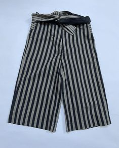 Elevate your wardrobe with these stunning Tom Rebl culottes, made in Italy from 100% high-quality cotton. The black and gray striped design adds a touch of sophistication to any outfit, while the comfortable and breathable material make them perfect for any occasion. These pants are a must-have for any fashion-forward woman's collection, with a stylish culotte cut that flatters the figure and adds a touch of elegance. The Size 46 is perfect for regular-sized women, while the Brand showcases the quality craftsmanship that has gone into creating these pants. Step out in style with these beautiful culottes! Womens Pants, Black And Gray, Grey Stripes, Stripes Design, Women Collection, The Black, Fashion Forward, Black And Grey, In Italy