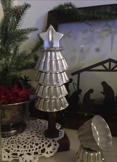 a christmas tree made out of tinsel next to other holiday decorations on a table