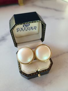 "These are a vintage pair of faux pearl circular clip-on earrings set in a gold tone metal.  Hallmarks: NONE  Weighs: .7oz  Measures 1\" x 1\" inches  All measurements are approximate.  Condition: Good vintage condition. Normal wear associated age. A few light surface scratches and slight discoloration. Please see photos. Sold as is. Priced accordingly.  Please look over carefully and inspect any and all photos. Our shop is committed to fully disclosing all items' conditions and history with as great of detail as possible. please consider this when examining all items in our shop. Simple wear and tear is normal for all vintage pieces.  Your jewelry will be packaged in a kraft gift box perfect for giving.  Some pictures are enlarged to show detail.  Does not include any props in photos.  Pl Luxury Clip-on Round Jewelry, Classic Round Clip-on Earrings For Formal Occasions, Classic Pearl Drop Clip-on Earrings, Classic Clip-on Pearl Drop Earrings, Classic Round Clip-on Earrings With Pearl Drop, Classic Round Pearl Drop Clip-on Earrings, Formal Round Clip-on Earrings, Vintage Pearl Clip-on Earrings For Formal Occasions, Vintage Pearl Earrings For Formal Occasions