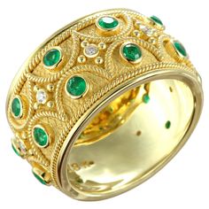 Indulge in the allure of elegance with our exquisite emerald gold ring, adorned with radiant brilliance and delicate golden accents reminiscent of twisted ropes. Featuring captivating round emeralds, this timeless piece exudes sophistication and charm, making it a perfect statement of refined luxury for any occasion. 100% handmade in our workshop. Metal: 18K Gold Gemstones: Emerald weight 0,74 ct Diamond weight 0,08 ct Ring Size: 7.5 (free sizing) Discover the art of personalization as you select your dream jewelry, choosing the perfect gemstone that resonates with your unique style. Our dedicated team is always ready to assist, ensuring a seamless experience. Each exquisite piece in our collection bears a distinctive hallmark, symbolizing our unwavering commitment to quality, authenticity Emerald Gold Ring, Silver Jewelry Design, Charm Making, Jewellery Ideas, Dream Jewelry, Timeless Pieces, Gold Ring, Band Rings, Your Dream