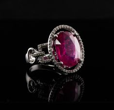 Diamond Pink Ruby Ring, 14K White Gold Oval (6.16ct) Ruby. This gorgeous vintage estate ring is finely crafted in solid 14K White gold and set with natural Earth mined Pink Ruby and genuine diamonds.  The center oval cut gem measures 14mm x 11mm (6.16 carats).  This is a very good quality stone with great intensity and strong brilliance.  The center stone is surrounded by 44 diamonds plus 26 diamonds on the sides. These diamonds are SI clarity and H color totaling (.70cttw) The top of the ring measures 19mm x 16mm.  Size 6.5 (can be sized).  The ring weighs 8.4 grams.  Great estate condition. * * * * * * * * PLEASE, READ DESCRIPTIONS CAREFULLY. Choose ACCORDINGLY. We want you to be completely satisfied with your purchase. If for any reason you are not entirely pleased, simply return the it Luxury Oval Ruby Ring With Prong Setting, Luxury Oval Ruby Ring With Center Stone, Luxury Ruby Ring With Oval Center Stone, Elegant Gia Certified Oval Ruby Ring, Luxury Oval Ruby Ring For Formal Occasions, Luxury Oval Ruby Ring With Gemstone, Elegant Oval Ruby Ring With Vvs Clarity, Ruby Ring Vintage, Estate Ring