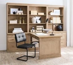 an office desk with bookshelves and chairs