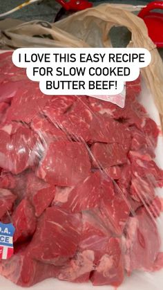 a pile of raw meat sitting on top of a white plate next to a bag of beef