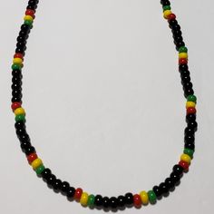 Jamaican/Rasta Colors Beaded Necklace Is Made With Size 6 Seed Bead Colors Are Opaque Cherry, Opaque Sunshine, Opaque Shamrock, And Black. 20 Inches In Length. Jamaican Beaded Necklace, Black Beaded Necklaces With Large Beads, Casual Multicolor Jewelry With Black Beads, Casual Black Beaded Necklaces For Festival, Handmade Black Beaded Necklace For Festivals, Black Necklaces With Colorful Beads For Festivals, Casual Black Beaded Necklace With Colorful Beads, Black Single Strand Bohemian Beads, Black Single Strand Bohemian Jewelry