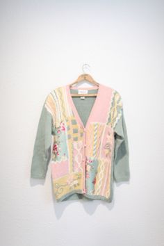 "maker: cervelle material: raimie cotton fits like a n oversized small/medium used vintage condition length: 30\", pit to pit:25\", shoulders:25\", shoulder to wrist:20\"" Pink Knit Sweater With Floral Print, Vintage Floral Print Spring Cardigan, Vintage Long Sleeve Sweater With Floral Print, Vintage Green Knit Outerwear, Vintage Multicolor Cotton Cardigan, Vintage Floral Print Cardigan For Fall, Fall Vintage Floral Print Cardigan, Pink Bohemian Cotton Cardigan, Vintage Green Cardigan For Spring