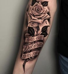 a black and white rose tattoo on the arm