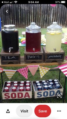 an outdoor table with sodas and lemonade on it