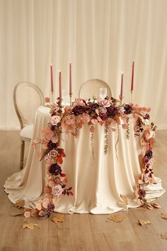 a table with flowers and candles on it