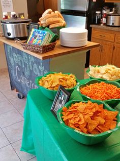 several bowls filled with different types of food on top of a green cloth covered table