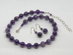 "Gorgeous 12mm Faceted Purple Cape Amethyst Beads with 5mm Amethyst Rondelle spacers in a hand beaded Necklace. Matching drop earrings with Sterling Silver Fancy French ear wires. All Sterling Silver (.925) Lobster Clasp and Findings. All handcrafted and hand wire wrapped. A shorter necklace at 18 inches that includes a 3 inch Sterling Silver Extender for a total length of 21 inches. Lays beautifully on the nape of the neck. Elegant and Classic Styling. Wear for any occasion, an evening out or c Lavender Round Jewelry With Faceted Beads, Faceted Round Amethyst Beads, Lavender Round Polished Beads Jewelry, Purple Beaded Necklace, Purple Cape, Purple Bead Necklace, Hand Beaded Necklace, Feminine Necklace, Necklace Matching