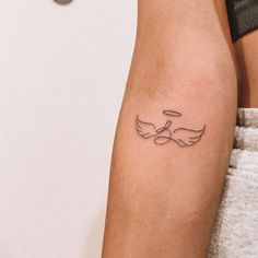 a woman's arm with a tattoo on it that has two birds in the middle