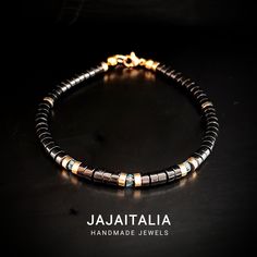 Elevate your style with the Minimalist Men's Bracelet. This handcrafted jewel is a perfect union of design and nature, made with 4mm polished onyx beads and embellished with three sparkling topazes set between elegant golden hematite rondels. The bracelet, which fits discreetly on the male wrist, is a symbol of refinement and inner strength. Onyx, known for its protective and resilient properties, and topaz, a stone of mental clarity and abundance, come together in an accessory that goes beyond Modern Bracelets With Spacer Beads As A Gift, Modern Adjustable Black Beaded Jewelry, Modern Gemstone Beaded Bracelets As Gift, Modern Gemstone Beaded Bracelets For Gift, Modern Hematite Bracelets As A Gift, Modern Black Hematite Jewelry, Modern Black Beads Bracelets As Gift, Modern Black Beaded Bracelets As Gift, Modern Black Beads Bracelet As Gift