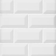 a white brick wall that is very close to the ground