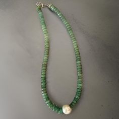 Add a touch of elegance to your collection with this stunning Smooth Green Quartz Necklace. Featuring smooth green quartz rondelle gemstones and an exquisite single round pearl as the focal point, this 18-inch necklace is perfect for those who love minimalist yet eye-catching designs. The silver lobster clasp ensures a secure and comfortable fit, making it an ideal choice for everyday wear or special occasions. The soft green hues of the quartz combined with the classic pearl create a harmonious Classic Green Gemstone Beads Necklace, Elegant Green Round Beaded Necklaces, Elegant Green Round Beaded Necklace, Elegant Green Onyx Beaded Necklaces, Elegant Green Pearl Necklace With Natural Stones, Elegant Green Jade Pearl Necklace, Elegant Green Onyx Round Necklace, Elegant Green Onyx Round Necklaces, Elegant Green Single Strand Pearl Necklace