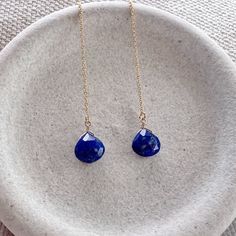 Our dainty lapis lazuli thread earrings are the perfect lightweight everyday earring. As simple as they are, the dangling sparkling semi precious lapis gemstone really makes a statement. We offer a choice of every month's birthstone as well as other popular gemstones in the drop-down menu. We also offer these earrings in gold filled, sterling silver, rose gold and 14k gold. If you need your order by a certain date, it is very important to send us a message on Etsy directly after you place your order, as well as write it in the 'Notes to Seller' at checkout.  For more information, please refer to our FAQ page. Jewelry is handmade by us in NYC focusing on quality using only the highest quality materials and handpicked genuine gemstones.   ▹ PACKAGING All jewelry is beautifully wrapped in tis Blue Dangle Jewelry With Adjustable Chain, Blue Adjustable Long Drop Jewelry, Dainty Blue Drop Earrings, Dainty Blue Drop Jewelry, Blue Nickel-free Linear Earrings For Gift, Minimalist Blue Teardrop Jewelry, Blue Linear Earrings With Ear Wire For Gift, Blue Long Drop Teardrop Earrings Gift, Blue Long Drop Teardrop Earrings For Pierced Ears