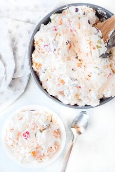 a bowl filled with food next to a spoon on top of a white tablecloth