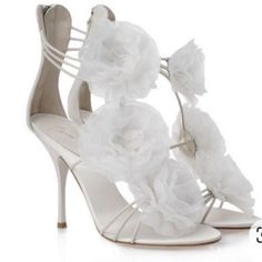 Product Information Straps In White Leather And Organza Floral Details Have Been Used To Form This Gorgeous Pair By Giuseppe Zanotti. The Strappy Layout, Open Toe, And Back Zip Closure Are Added To Frame Your Feet In An Alluring Way. Leather-Lined Insoles And Slim Heels Finish The Luxe Pair. Gender Women Includes The Luxury Closet Packaging Size 39.5 Exterior Material Fabric, Leather Lining Material Leather Insole Material Leather Sole Material Leather Origin Italy Closure Type Zipper Outsole Le Elegant Flower-shaped Sandals With Heel Strap, Designer White Heels For Gala, Chic Wedding Heels With Flower Detail, Elegant Flower-shaped Party Sandals, Elegant Flower-shaped Sandals For Parties, Elegant Formal Flower Sandals, Luxury Spring Wedding Shoes With Ankle Strap, Elegant Flower Shaped Sandals For Party, Designer White Wedding Sandals