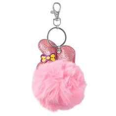 a pink keychain with a bow on it and a fuzzy ball hanging from the front