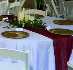 the table is set with white and gold plates