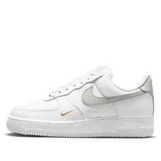 The Nike Air Force 1 'White Light Silver' is a classic silhouette with a modern twist. Crafted from white leather, the sneaker features signature perforations on the toe box and side panels. Detailed with gray leather Swooshes, tongue label, and gold embroidered brand logo on the side and heel, this sneaker is finished with a durable white rubber sole. Perfect for everyday wear, this timeless design is inspired by the original Air Force 1 series and is sure to be a staple in any wardrobe. (AF1/S Gold Nike Shoes, Nike Air Force Low, Tenis Air Force, White Air Force Ones, Sneakers Air Force, Gray Nike Shoes, Air Force Women, Gold Nike, White Air Forces