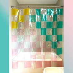 a bathroom with a checkered shower curtain next to a sink