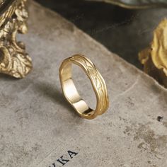 a gold ring sitting on top of a stone slab