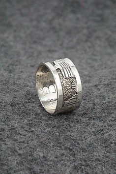 This sterling silver ring featuring a southwest landscape was made by Navajo silversmith Elaine Becenti. The inside is signed B and stamped sterling.Size: 8Width: 3/8"Free shipping on all orders! We ship with USPS and always include tracking. All orders ship within a day of payment.Returns are accepted up to 30 days after you receive your order. Just send us a message. Our shop offers cash back or store credit. The item must be returned in new condition. Collectible Sterling Silver Ring With Wide Band, Artisan Sterling Silver Wide Band Ring, Artisan Sterling Silver Ring With Etched Details, Artisan Sterling Silver Etched Rings, Bohemian Sterling Silver Engraved Ring For Anniversary, Sterling Silver Stamped Rings For Collectors, Sterling Silver Engraved Wide Band Ring, Unique Engraved Wide Band Ring In Sterling Silver, Artisan Stamped Rings For Anniversary