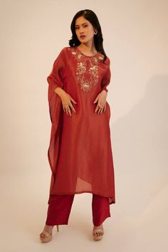 Red kaftan kurta with floral embroidery on the yoke. Paired with a pant.
Components: 2
Pattern: Embroidered
Type Of Work: Sequin, Thread
Neckline: Round
Sleeve Type: Three-quarter
Fabric: Tissue Georgette, Silk
Color: Red
Other Details: 
Attached lining
Approx. product weight: 1kg
Pant closure: Button
Occasion: Mehendi and Haldi - Aza Fashions Red Palazzo Set With Embroidered Border And Straight Kurta, Red Palazzo Set With Straight Kurta And Embroidered Border, Festive Kaftan With Floral Embroidery, Red Embroidered Straight Kurta Kaftan, Eid Floral Embroidered Chanderi Kaftan, Red Palazzo Set With Embroidered Border For Eid, Embroidered Red Straight Kurta Kaftan, Eid Chanderi Kaftan With Floral Embroidery, Chanderi Kaftan With Embroidered Border