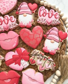 decorated cookies in the shape of gnomes and hearts on a wicker platter