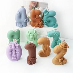 there are many different shaped candles in the shape of animals