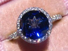 Moissanite Halo Engagement Ring With Jubilee Cut Lab Blue | Etsy Formal Tanzanite Halo Ring, Dazzling Sapphire Ring With Halo Setting For Formal Occasions, Elegant Tanzanite Halo Ring, Luxury Sapphire Halo Ring With Prong Setting, Luxury Tanzanite Jewelry With Halo Setting, Formal Sapphire Halo Ring With Diamonds, Luxury Sapphire Diamond Halo Ring, Luxury Sapphire Halo Ring With Brilliant Cut, Luxury Sapphire Jewelry With Halo Setting