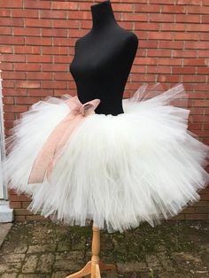 "This listing includes an ivory tutu with an ivory satin bow also includes the rose gold accent bow clip. This listing if for waist sizes 45 1/2 up to 55 1/2\" can be made larger if interested contact me for a special listing. Other colors also available. The ivory tutu with the rose gold bow clip has a longest length of 18\" and top layer of 13\". The ivory tutu with just the satin bow is the 13-18\" length range with a longest layer of 15\" and top layer of 12\". Tutu can be all one length or Fitted White Tutu Dress With Bow, White Fitted Tutu Dress With Bow, Fitted White Skirt With Bow, White Princess Tutu Dress With Bow, White Princess Style Tutu Dress With Bow, Cream Tulle Tutu Dress For Wedding, Cream Tulle Skirt Tutu Dress For Baptism, White Tulle Petticoat For Party, White Tulle Tutu Dress For Party