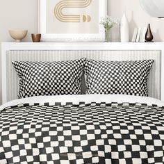 a black and white checkered comforter on a bed